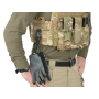 Action or staged product shot showing the snap hook mounted onto MOLLE webbing on a tactical plate carrier.